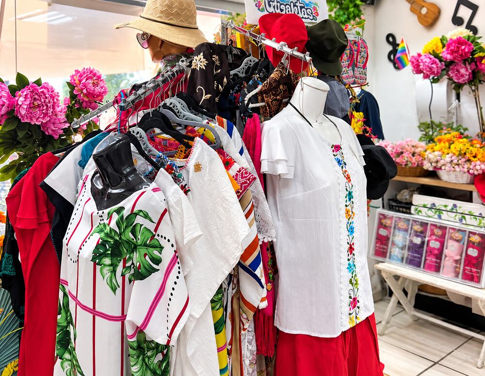 Beachwear and embroidered blouses on display at Farmacia Olas Altas