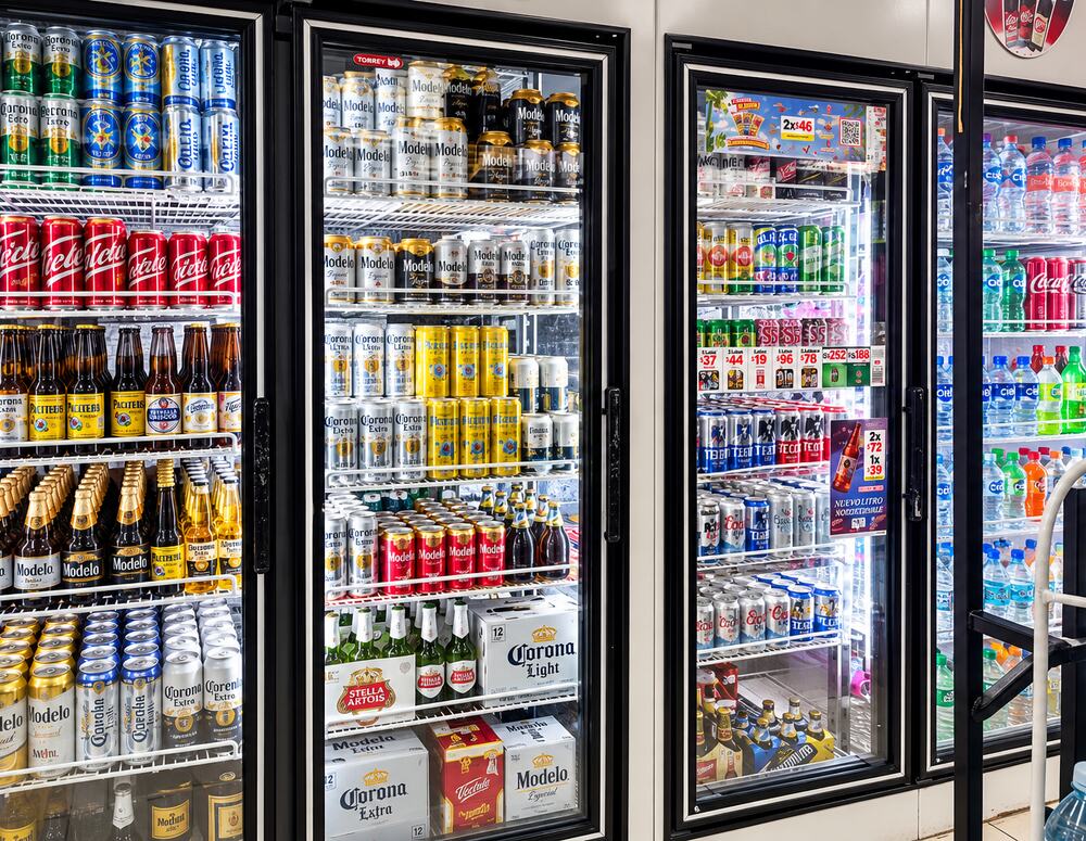 Chilled coolers stocked with beer, wine and spirits at Farmacia Olas Altas